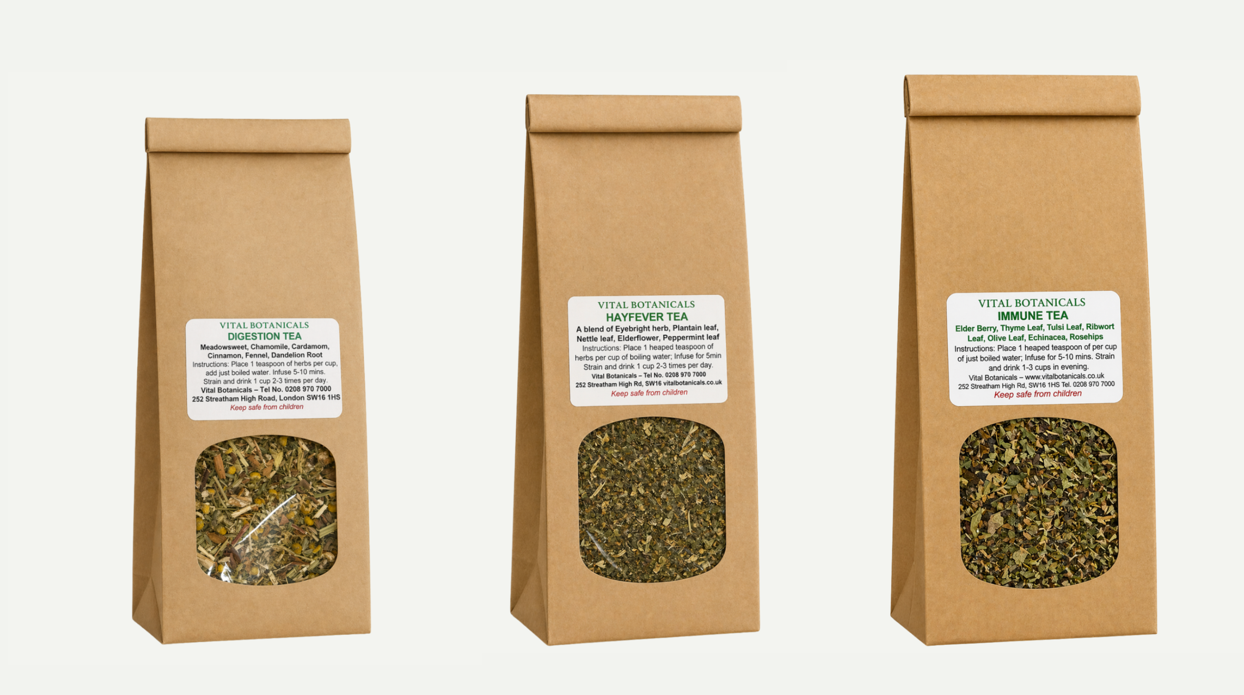 Three brown paper bags with tea leaves and labels on a white background