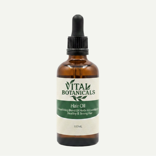 Vital Botanicals hair oil bottle with dropper on a white background