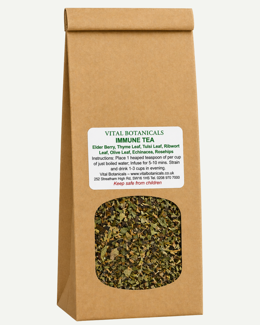 Brown paper bag of Vital Botanicals Immune Tea with visible tea leaves and label.